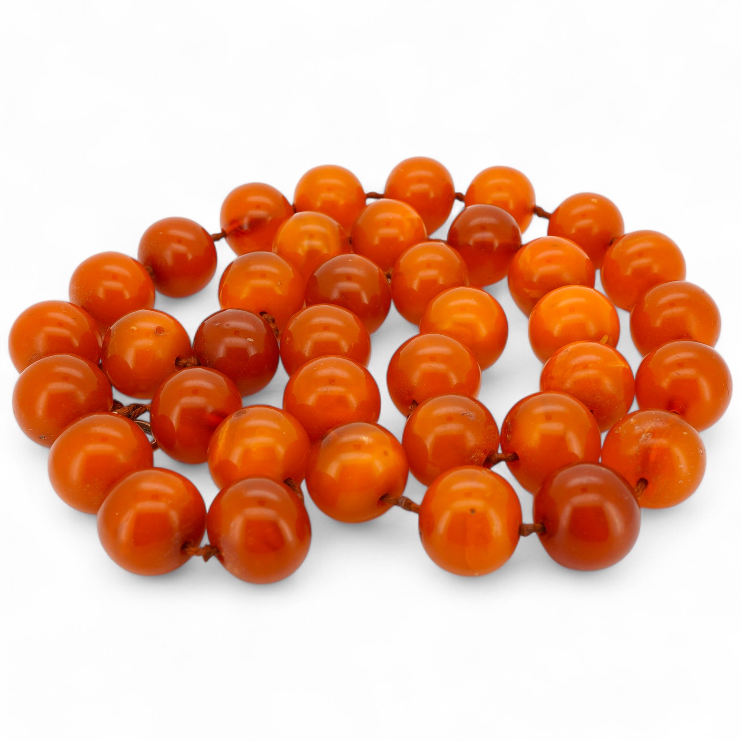 A single strand circular amber bead necklace, 56cm, gross weight 55 grams.
